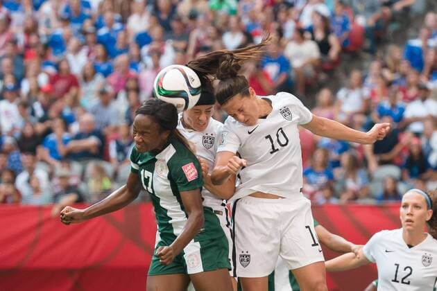 June 16, 2015: Francisca ORDEGA of Nigeria and Carli LLOYD of the USA jump for the ball during a Group D match at the FIFA Women s World Cup Canada 2015 between Nigeria and the USA at BC Place Stadium on 16 June 2015 in Vancouver, Canada. USA won 1-0. Sydney Low Cal Media. Soccer 2015: FIFA Women s World Cup JUNE 16 - ZUMAc04_