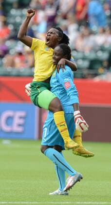 16 JUNE 2015: Cameroon s Christine Manie (2) jumps in the arms of goalkeeper .Annette Ngo Ndom (1) after their teams second goal against Switzerland at the FIFA Womens World Cup at Commonwealth Stadium in Edmonton, Alberta, Canada. SOCCER: JUN 16 FIFA Women s World Cup - Group C - Switzerland v Cameroon Icon20150611015 EDITORIAL USE ONLY