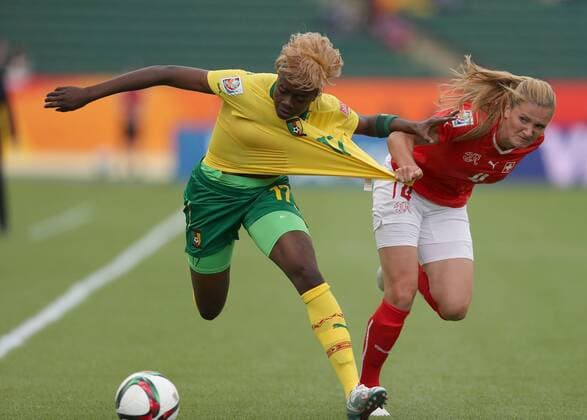 EDMONTON, June 16, 2015 -- Gaelle Enganamouit (L) of Cameroon vies with Rachel Rinast of Switzerland during their group C match at the 2015 FIFA Women s World Cup in Edmonton, Canada, June 16, 2015. Cameroon won 2-1 and was qualified for the round of 16. ) (SP)CANADA-EDMONTON-FIFA WOMEN S WORLD CUP-GROUP A-SWITZERLAND VS CAMEROON QinxLang 