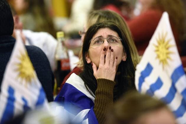MONTEVIDEO, June 16, 2015 -- A fan of Uruguay reacts while watching the live broadcast of the Group B match of the Copa America Chile 2015 between Argentina and Uruguay, in a bar in Montevideo, capital of Uruguay, on June 16, 2015. ) (da) (SP)URUGUAY-MONTEVIDEO-COPA AMERICA-ARGENTINA VS URUGUAY-FANS NICOLASxCELAYA 