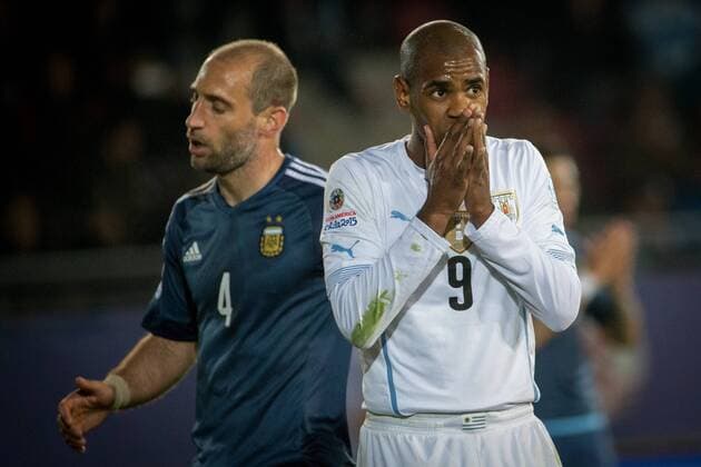LA SERENA, June 16, 2015 -- Pablo Zabaleta (L) of Argentina and Diego Rolan of Uruguay react during the Group B match at the 2015 American Cup, at La Portada stadium, in La Serena, Chile, on June 16, 2015. Argentina won 1-0. ) (ce) (SP)CHILE-LA SERENA-COPA AMERICA-ARGENTINA VS URUGUAY PedroxMera 