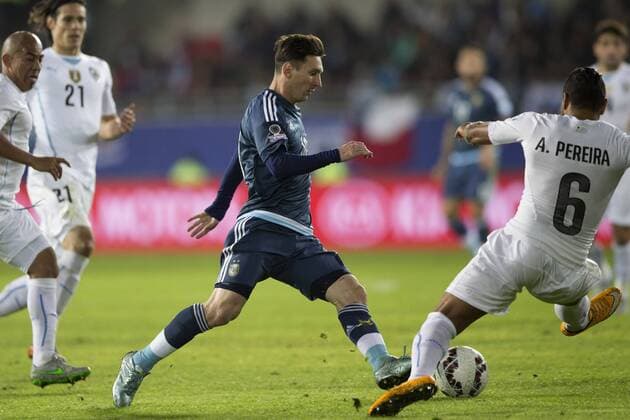 LA SERENA, June 16, 2015 -- Lionel Messi (C) of Argentina vies for the ball with Alvaro Pereira of Uruguay during the Group B match at the 2015 American Cup, at La Portada stadium, in La Serena, Chile, on June 16, 2015. Argentina won 1-0. ) (ce) (SP)CHILE-LA SERENA-COPA AMERICA-ARGENTINA VS URUGUAY LuisxEcheverria 