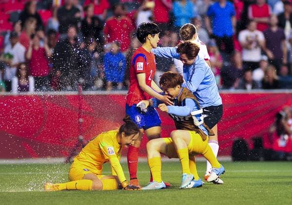 June 17, 2015: Goalkeeper Kim Jungmi ( 18) and Lee Eunmi ( 2) of Korea Republic are sprayed with water in celebration after the FIFA 2015 Women s World Cup Group E match between Korea and Spain at Lansdowne Stadium in Ottawa, Canada. Korea recovered from a 1-0 deficit at half time to win 2-1 and progress to the knockout stages. SOCCER: JUN 17 FIFA Women s World Cup - Group E - Korea v Spain Icon15061700022 EDITORIAL USE ONLY