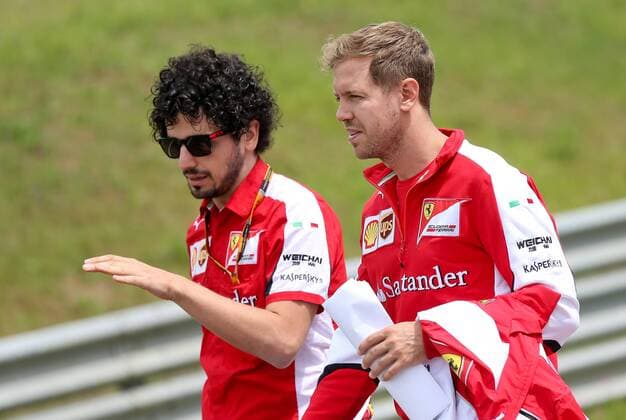 FORMULA 1 - GP of Austria 2015 SPIELBERG,AUSTRIA,18.JUN.15 - MOTORSPORTS, FORMULA 1 - Grand Prix of Austria, Red Bull Ring, preview. Image shows Sebastian Vettel (GER Scuderia Ferrari) with a team member. GEPAxpictures xChristianxWalgram