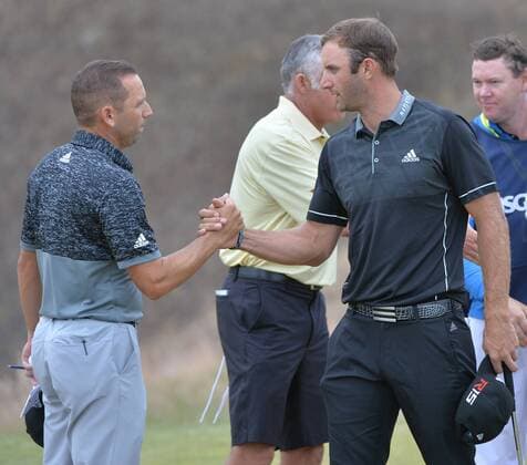 Dustin Johnson (R) shakes hands with Sergio Garcia of Spain after completing round one of the 115th U.S. Open Championship at Chambers Bay on June 18, 2015 in University Place, Washington. Johnson ended the day five under par.  SEA20150618281 KEVINxDIETSCH