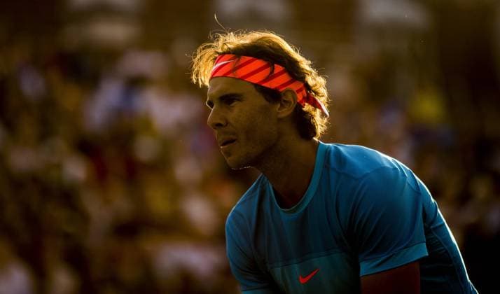18.06.2015. London, England. Queens Aegon Championship Tennis. The evening sun highlights the headband worn by Rafael Nadal (ESP) in his loss, with partner Lopez to D. Nestor and L. Paes in the quarter-finals. xNigelxCookex  ActionPlus11633097