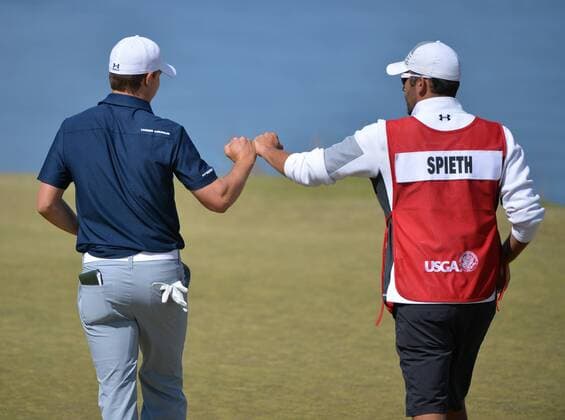 Jordan Spieth bumps fists with caddie Michael Greller on the 16th hole in the second round of the 115th U.S. Open Championship at Chambers Bay on June 19, 2015 in University Place, Washington.  SEA20150619024 KEVINxDIETSCH