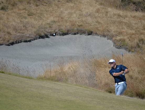 Jordan Spieth hits from a bunker on the 18th hole in the second round of the 115th U.S. Open Championship at Chambers Bay on June 19, 2015 in University Place, Washington.  SEA20150619027 KEVINxDIETSCH