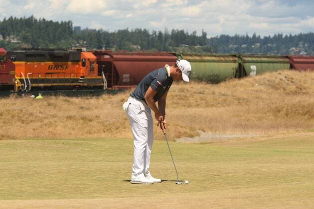 Ryan Palmer gets read to putt on the 17th green as a train goes by in the second round of the 115th U.S. Open Championship at Chambers Bay on June 19, 2015 in University Place, Washington.  SEA20150619030 JIMxBRYANT