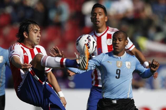 Football , Uruguay v Paraguay Copa America 2015 . Paraguay s Osmar Molinas, left, battles for the ball agains Alvaro Pereira of Uruguay during the match of group B of the 2015 Copa America at La Serena stadium. Rancagua, Chile. 20 06 2015 Marcelo Hernandez Photosport Uruguay v Paraguay, Copa America 2015. 