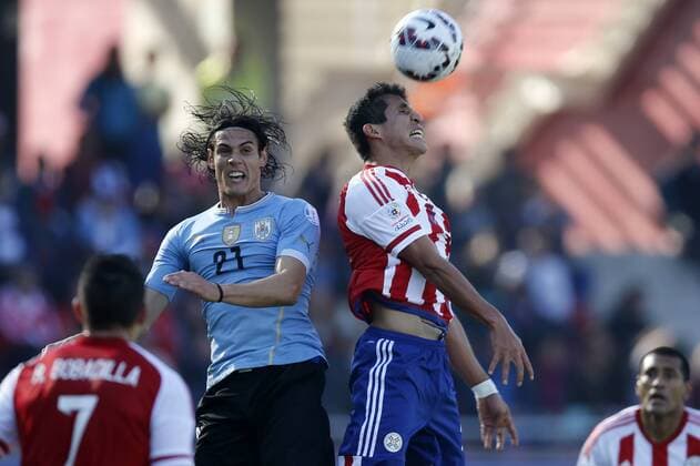 Football , Uruguay v Paraguay. Copa America Championship 2015 . Paraguay s player Marcos Cáceres, right, battles for the ball against Edinson Cavani of Uruguay during the group B football match of the 2015 Copa America at the La Portada stadium in Santiago.. 20 06 2015 Andres Pina Photosport Uruguay v Paraguay, Copa America 2015. 