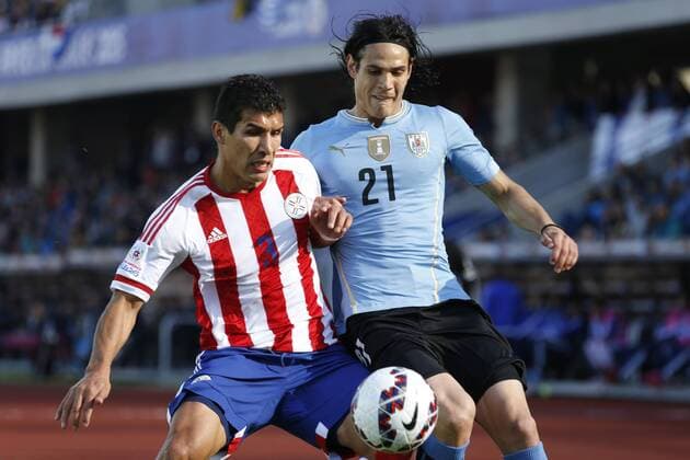 Football , Uruguay v Paraguay Copa America 2015 . Uruguay s Edinson Cavani, right, battles for the ball agains Marcos Caceres of Paraguay during the match of group B of the 2015 Copa America at La Serena stadium. Rancagua, Chile. 20 06 2015 Marcelo Hernandez Photosport Uruguay v Paraguay, Copa America 2015. 