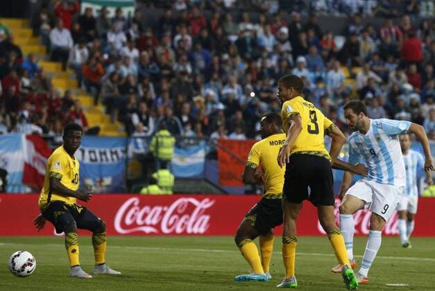 Football , Argentina v Jamaica Copa America 2015 . Argentina s player Gonzalo Higuain, right, scores against Jamaica during the group B of the 2015 Copa America football match held at the Sausalito stadium in Vina del Mar, Chile. 20 06 2015 Martin Thomas Photosport Argentina v Jamaica, Copa America 2015. 