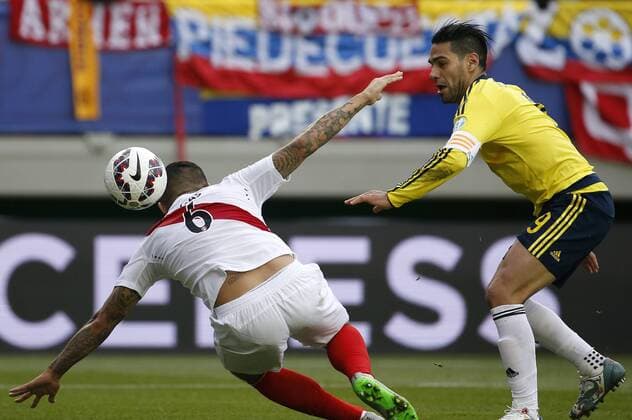 Football, Colombia v Peru. Copa America 2015. Colombia s player Ramadel Falcao, right, battles for the ball against Juan Vargas of Peru during the Copa America Group C, at German Becker stadium. Temuco. 21 06 2015 DragomirYankovic Photosport Colombia v Peru, Copa America 2015. 