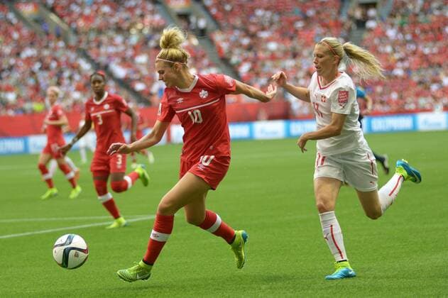 Lauren Sesselmann (L) of Canada vies with Lara Dickenmann of Switzerland during a Round of 16 match at FIFA Women s World Cup Canada 2015 in Vancouver, Canada, June 21, 2015. Canada defeated Switzerland 1-0. ) (SP)CANADA-VANCOUVER-FIFA WOMEN S WORLD CUP-ROUND OF 16-CANADA VS SWITZERLAND SergeixBachlakov 