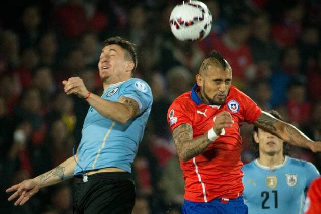 SANTIAGO, 2015 -- Arturo Vidal (R) of Chile fights for the ball with Cristian Rodriguez of Uruguay during their quarterfinal at 2015 Copa America in Santiago, Chile, on June 24, 2015. ) (SP)CHILE-SANTIAGO-COPA AMERICA-CHILE VS URUGUAY PedroxMera 