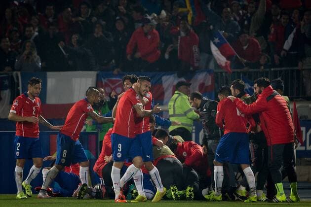 SANTIAGO, 2015 -- Players of Chile celebrate scoring against Uruguay during their quarterfinal at 2015 Copa America in Santiago, Chile, on June 24, 2015. Chile won 1-0. Jorge Villegas) (SP)CHILE-SANTIAGO-COPA AMERICA-CHILE VS URUGUAY PedroxMera 