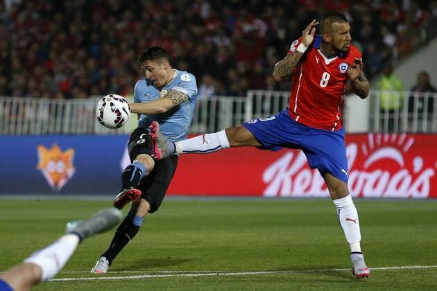 Copa America Championship 2015 . Uruguay s player Cristian Rodriguez, left, battles for the ball against Arturo Vidal of Chile during the group A of the 2015 Copa America football match at the National stadium in Santiago, Chile. 24 06 2015 Andres Pina Photosport Chile v Uruguay, Copa America 2015. 