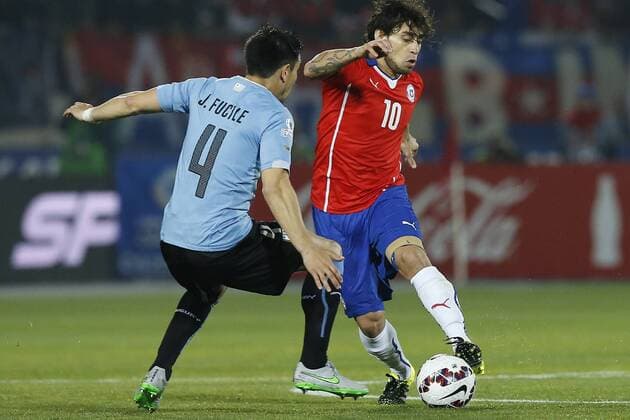 Chile v Uruguay. Copa America 2015 . Chile s Jorge Valdivia, righ, battles for the ball against Jorge Fucile of Uruguay during the match of quarter finals of the 2015 Copa America at La Serena stadium. Santiago, Chile. 24 06 2015 Marcelo Hernandez Photosport Chile v Uruguay, Copa America 2015. 
