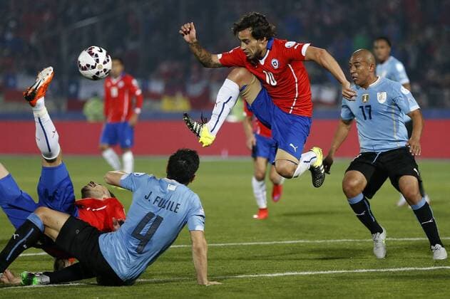 Copa America Championship 2015 . Chile s player Jorge Valdivia, center, battles for the ball against the defense of Uruguay during the group A of the 2015 Copa America football match at the National stadium in Santiago, Chile. 24 06 2015 Andres Pina Photosport Chile v Uruguay, Copa America 2015. 