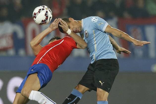 Chile v Uruguay. Copa America 2015 . Chile s Alexis Sanchez, left , battles for the ball against Maximiliano Pereira of Uruguay during the match of quarter finals of the 2015 Copa America at La Serena stadium. Santiago, Chile. 24 06 2015 Marcelo Hernandez Photosport Chile v Uruguay, Copa America 2015. 
