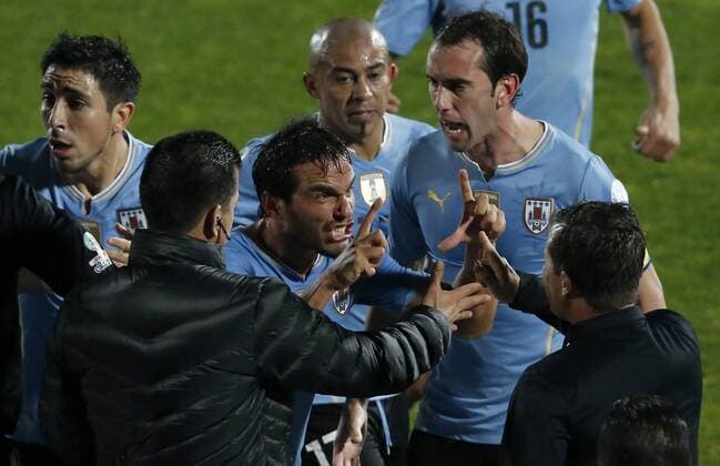 Chile v Uruguay. Copa America 2015 . Uruguay s players argue with the refereee during the 2015 Copa America football match played against Chile at the Nacional stadium in Santiago, Chile. 24 06 2015 Martin Thomas Photosport Chile v Uruguay, Copa America 2015. 