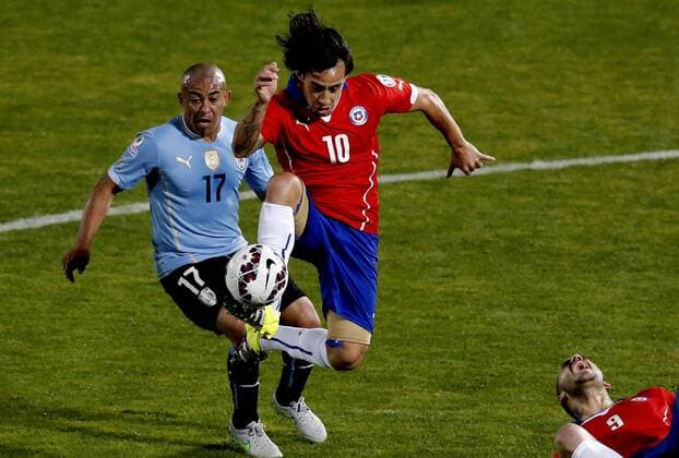 Copa America 2015 . Chile s player Jorge Valdivia, right, battles for the ball against Egidio Arevalo of Uruguay during the 2015 Copa America football match held at the Nacional stadium in Santiago, Chile. 24 06 2015 Martin Thomas Photosport Chile v Uruguay, Copa America 2015. 