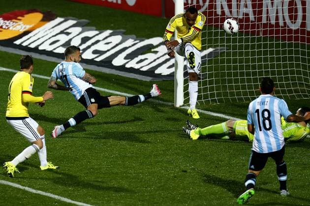 Football , Argentina v Colombia. Copa America Championship 2015 . Argentina s player Nicolas Otamendi, center battles for the ball against Juan Carlos Zuniga of Colombia during the 2015 Copa America football championship quarterfinal match at the Sausalito stadium in Vina del Mar, Chile. 26 06 2015 Adrian Aylwin Photosport Argentina v Colombia, Copa America 2015. 