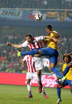 Brazil s Fernandinho (top R) vies with Paraguay s Pablo Aguilar during a quarter-final match between Brazil and Paraguay in Concepcion, Chile, June 27, 2015. Paraguay defeated Brazil 4-3 on penalties after a 1-1 draw thus qualified to the semi-final round. ) (SP)CHILE-CONCEPCION-AMERICAN CUP-QUARTERFINAL-BRAZIL VS PARAGUAY XuxZijian 