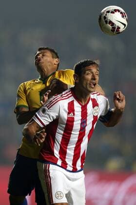 Brazil s Thiago Silva (L) vies the ball with Paraguay s Roque Santa Cruz during a quarter-final match between Brazil and Paraguay in Concepcion, Chile, June 27, 2015. Paraguay defeated Brazil 4-3 on penalties after a 1-1 draw thus qualified to the semi-final round. ) (vf) (SP)CHILE-CONCEPCION-AMERICAN CUP-BRAZIL VS PARAGUAY GuillermoxArias 