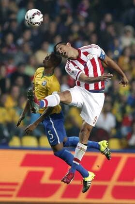 Brazil s Fernandinho (L) vies the ball with Paraguay s Roque Santa Cruz during a quarter-final match between Brazil and Paraguay in Concepcion, Chile, June 27, 2015. Paraguay defeated Brazil 4-3 on penalties after a 1-1 draw thus qualified to the semi-final round. ) (vf) (SP)CHILE-CONCEPCION-AMERICAN CUP-BRAZIL VS PARAGUAY GuillermoxArias 
