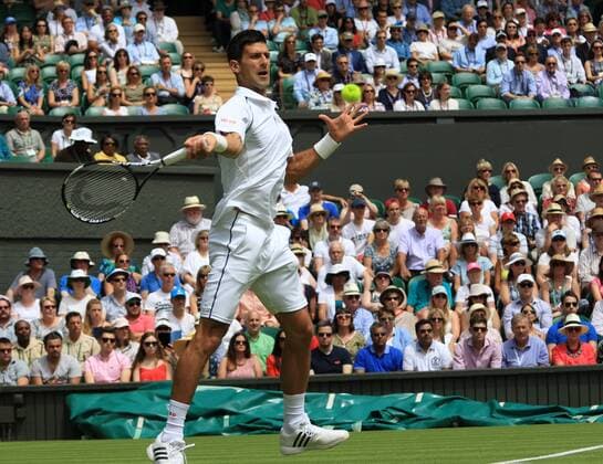 Serbia s Novak Djokovic plays a forehand against Germany s Philipp Kohlschreiber at the 2015 Wimbledon championships, London on June 29, 2015. Djokovic won the match 6-4, 6-4, 6-4.  LON2015062901 HUGOxPHILPOTT