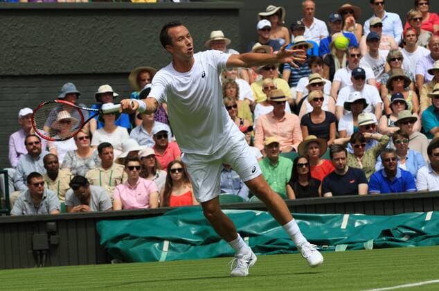 Germany s Philipp Kohlschreiber plays a forehand in his match against Serbia s Novak Djokovic at the 2015 Wimbledon championships, London on June 29, 2015. Djokovic won the match 6-4, 6-4, 6-4.  LON2015062907 HUGOxPHILPOTT