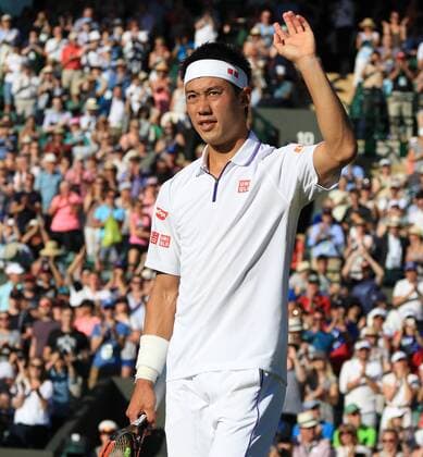 Japan s Kei Nishikori celebrates winning his match against Italy s Simone Bolleli on day one of the 2015 Wimbledon championships, London on June 29, 2015. Nishikori won the match 6-3, 6-7, 6-2, 3-6, 6.3.  LON2015062941 HUGOxPHILPOTT