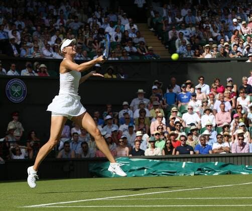Russian Maria Sharapova returns the ball in her match against Britain s Johanna Konta on day one of the 2015 Wimbledon championships, London on June 29, 2015. Sharapova won the match 6-2, 6-2.  LON2015062945 HUGOxPHILPOTT
