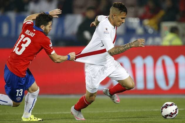 Peru s player Paolo Guerrero, center, battles for the ball against Jose Rojas of Chile during the 2015 Copa America football championship semifinal match at the National stadium in Santiago, Chile. 29 06 2015 AndresxPina Photosport Chile v Peru, Copa America 2015. 