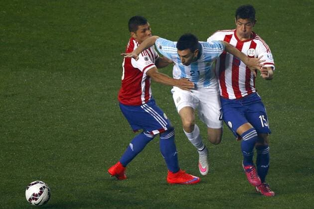 Argentina v Paraguay. Copa America Championship 2015 . Argentina s player Javier Pastore, center, battles for the ball against Richard Ortiz of Paraguay during the 2015 Copa America football championship semifinal match at the Ester Roa stadium in Concepcion . 30 06 2015 Adrian Aylwin Photosport Argentina v Paraguay, Semifinal Copa America 2015. 