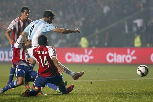 Copa America Championship 2015 . Argentina s player Gonzalo Higuain, left, scores against Paraguay during the 2015 Copa America football championship semifinal match at the Ester Roa stadium in Concepcion . 30 06 2015 Andres Pina Photosport Argentina v Paraguay, semifinal Copa America 2015. 