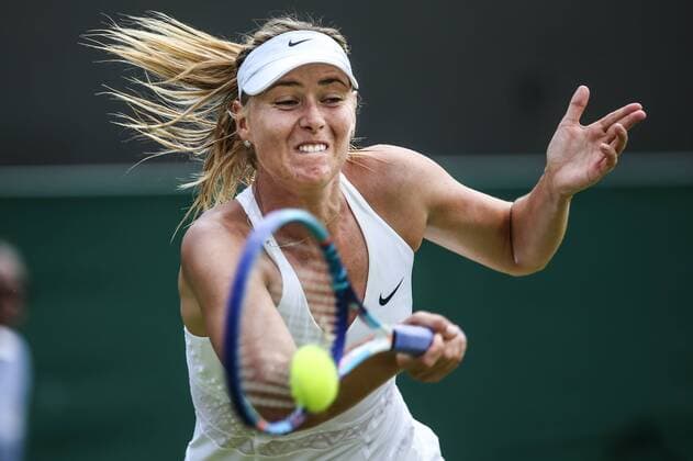 (150702) -- LONDON, Maria Sharapova of Russia returns the ball to Richel Hogenkamp of the Netherlands during the women s singles second round match at 2015 Wimbledon Tennis Championships in London, Britain, July 1, 2015. Sharapova won 2-0. ) (SP)BRITAIN-LONDON-TENNIS-WIMBLEDON CHAMPIONSHIPS TangxShi 