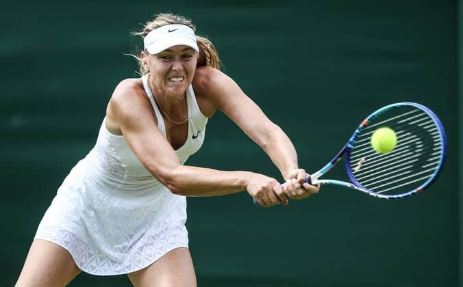 (150702) -- LONDON, Maria Sharapova of Russia returns the ball to Richel Hogenkamp of the Netherlands during the women s singles second round match at 2015 Wimbledon Tennis Championships in London, Britain, July 1, 2015. Sharapova won 2-0. ) (SP)BRITAIN-LONDON-TENNIS-WIMBLEDON CHAMPIONSHIPS TangxShi 