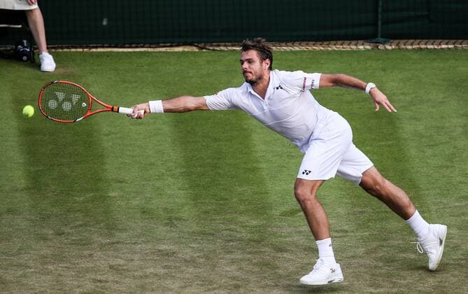 (150702) -- LONDON, Stan Wawrinka of Switzerland returns the ball to Victor Estrella Burgos of the Dominican Republic during the men s singles second round match at 2015 Wimbledon Tennis Championships in London, Britain, July 1, 2015. Wawrinka won 3-0. ) (SP)BRITAIN-LONDON-TENNIS-WIMBLEDON CHAMPIONSHIPS TangxShi 