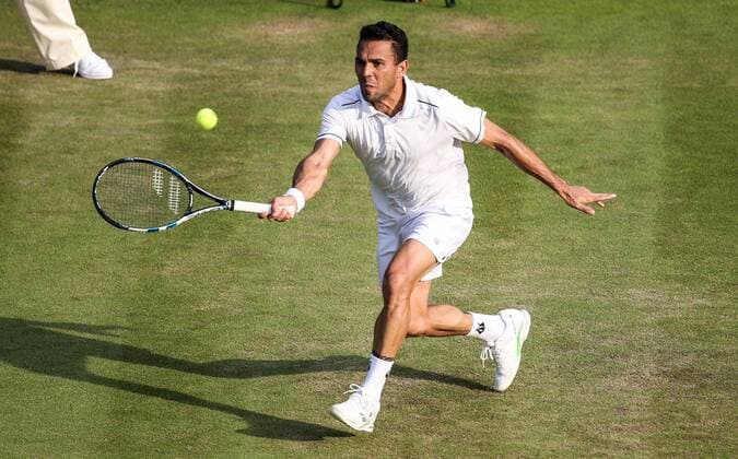 (150702) -- LONDON, Victor Estrella Burgos of the Dominican Republic returns the ball to Stan Wawrinka of Switzerland during the men s singles second round match at 2015 Wimbledon Tennis Championships in London, Britain, July 1, 2015. Wawrinka won 3-0. ) (SP)BRITAIN-LONDON-TENNIS-WIMBLEDON CHAMPIONSHIPS TangxShi 