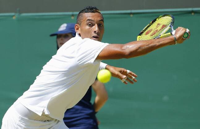Kyrgios in Wimbledon 3rd-round match Australia s Nick Kyrgios hits a backhand slice during his Wimbledon third-round match against Milos Raonic of Canada on July 3, 2015. 