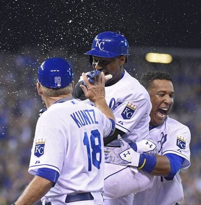 July 3, 2015 - Kansas City, MO, USA - The Kansas City Royals Jarrod Dyson celebrates with Salvador Perez, right, and first base coach Rusty Kuntz (18) after Dyson drove in the game-winning run on a fielder s choice in the 10th inning against the Minnesota Twins on Friday, July 3, 2015, at Kauffman Stadium in Kansas City, Mo. The Royals won, 3-2, in 10 innings. Minnesota at Kansas City - ZUMAm67_