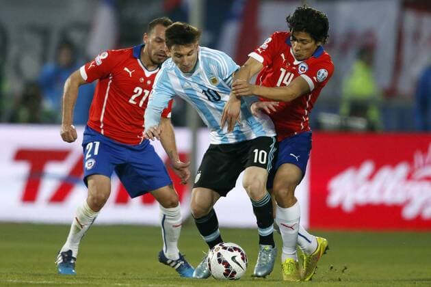 Football, Chile v Argentina. Copa America 2015 . Argentina s player, Lionel Messi, center, battles for the ball against Matias Fernandez of Chile during the finals of the Copa America 2015 football match held at the Nacional stadium in Santiago, Chile. 04 07 2015 Andres Pina Photosport Chile v Argentina, Copa America 2015. 