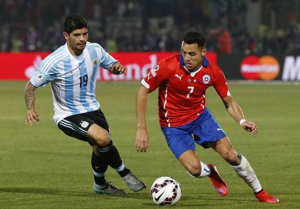 Football, Chile v Argentina. Copa America 2015 . Chile s player Alexis Sanchez, right, battles for the ball against Ever Bangs of Argentina during the finals of the Copa America 2015 football match held at the Nacional stadium in Santiago, Chile. 04 07 2015 Martin Thomas Photosport Chile v Argentina, Copa America 2015. 