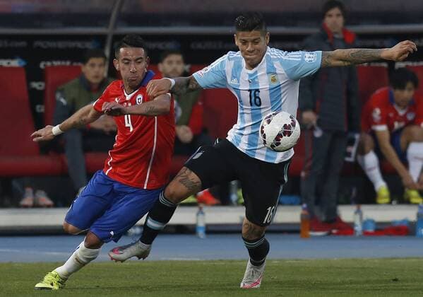 Football, Chile v Argentina. Copa America 2015 . Argentina s player Marcos Rojo, right, battles for the ball against Mauricio Isla of Chile during the finals of the Copa America 2015 football match held at the Nacional stadium in Santiago, Chile. 04 07 2015 Martin Thomas Photosport Chile v Argentina, Copa America 2015. 