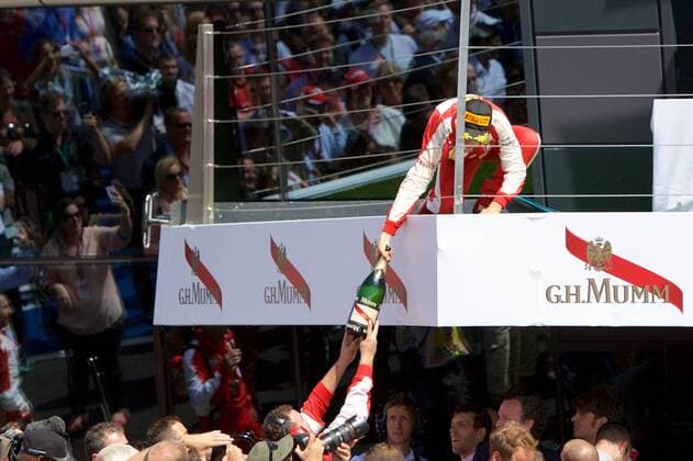 05.07.2015. Silverstone, Northants, England. Formula 1 British Grand Prix. Sebastian Vettel, Scuderia Ferrari gives the champagne to a team member. xTimxWilliamsx  ActionPlus11638034