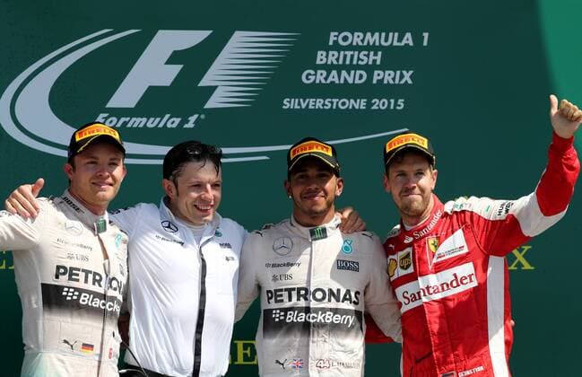 (150705) -- SILVERSTONE, July 5, 2015 -- Britian s Lewis Hamilton (2nd R) of Mercedes Team, his teammate Germany s Nico rosberg (1st L) and Germany s Sebastian Vettel of Ferrari Team pose for a group photo after 2015 Formula 1 British Grand Prix at Silverstone Circuit, Great Britain on July 5, 2015. ) (SP) BRITAIN-SILVERSTONE CIRCUIT-FORMULA 1-BRITISH GRAND PRIX HanxYan 