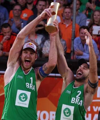 Alison Cerutti (L) and Bruno Oscar Schmidt (R) celebrates with trophy during the FIVB Beach volleyball Beachvolleyball World Championships Male Final Match between Brazil vs Netherlands on July 5, 2015 in The Hague, Netherlands. Imago Paulo Amorim